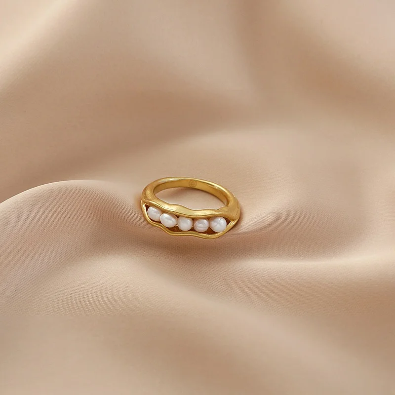 gold ring in index finger
